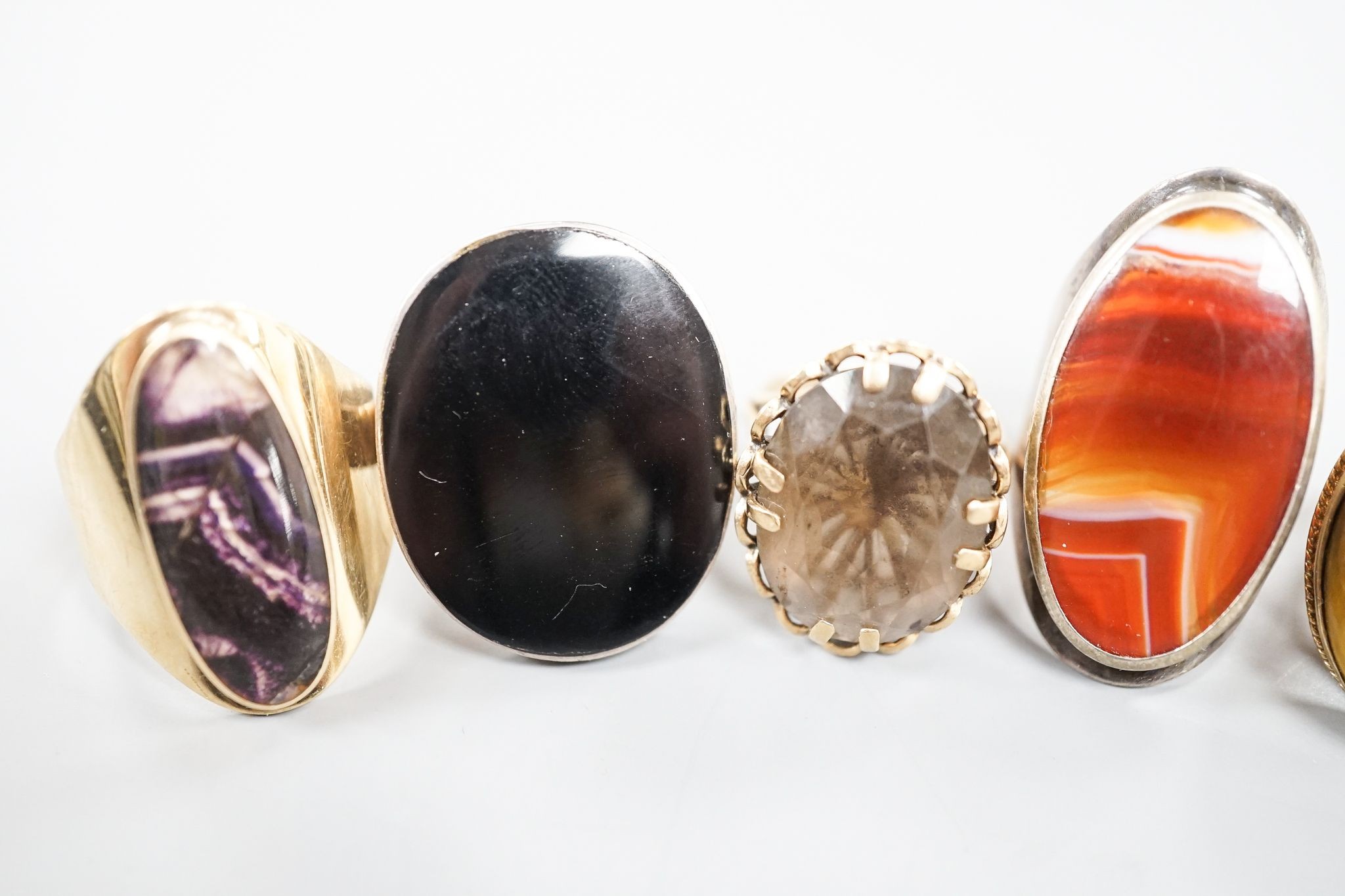 Three assorted 9ct gold and gem set dress rings, including blue john, smoky quartz and tiger's eye quartz, gross 23.9 grams and two white metal and hardstone set dress rings.